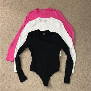 Black, White, and Pink Long Sleeve Bodysuits